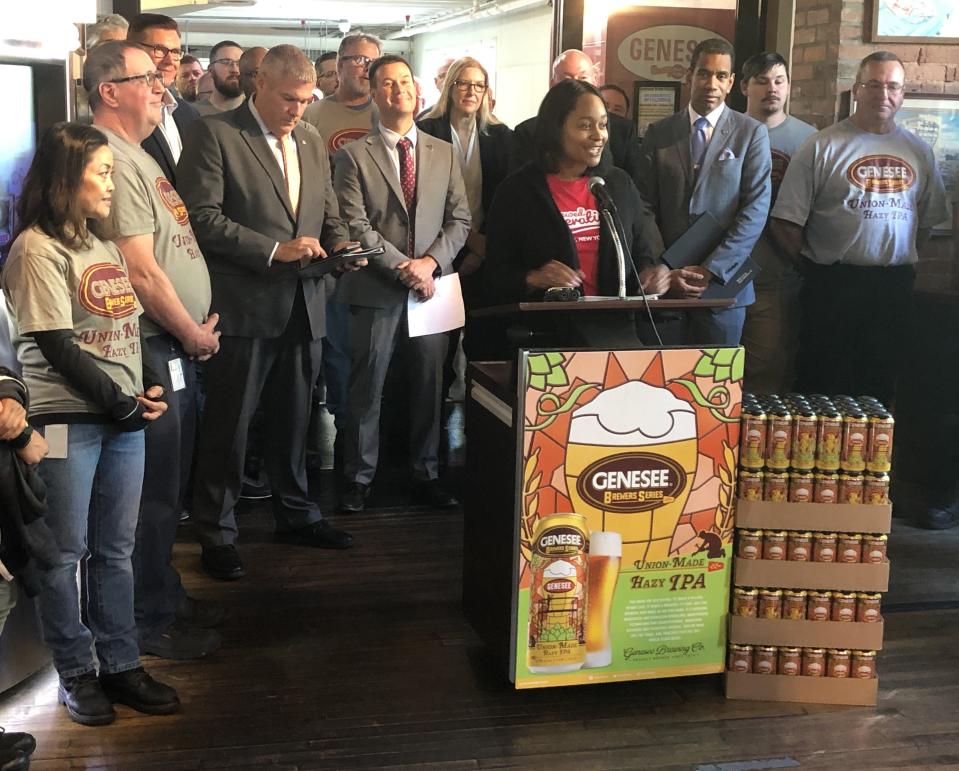 Tiffany Benning, brand manager for Genesee Brewery, announces the new Union-Made Hazy IPA at a press conference Tuesday at the Genesee Brew House in Rochester as union leaders, Rochester Mayor Malik Evans and Monroe County Executive Adam Bello look on.