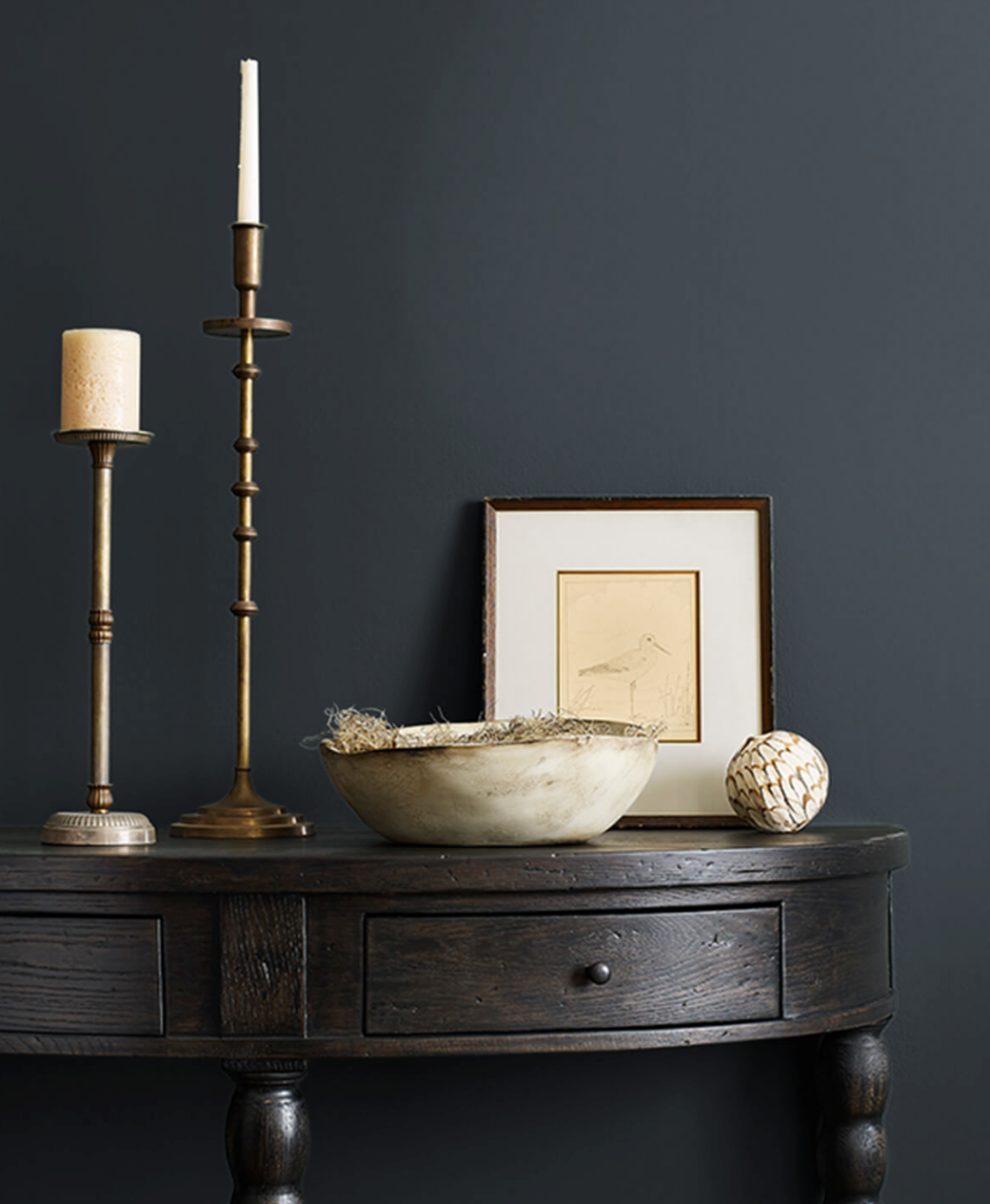 dark colored hallway table against dark colored wall