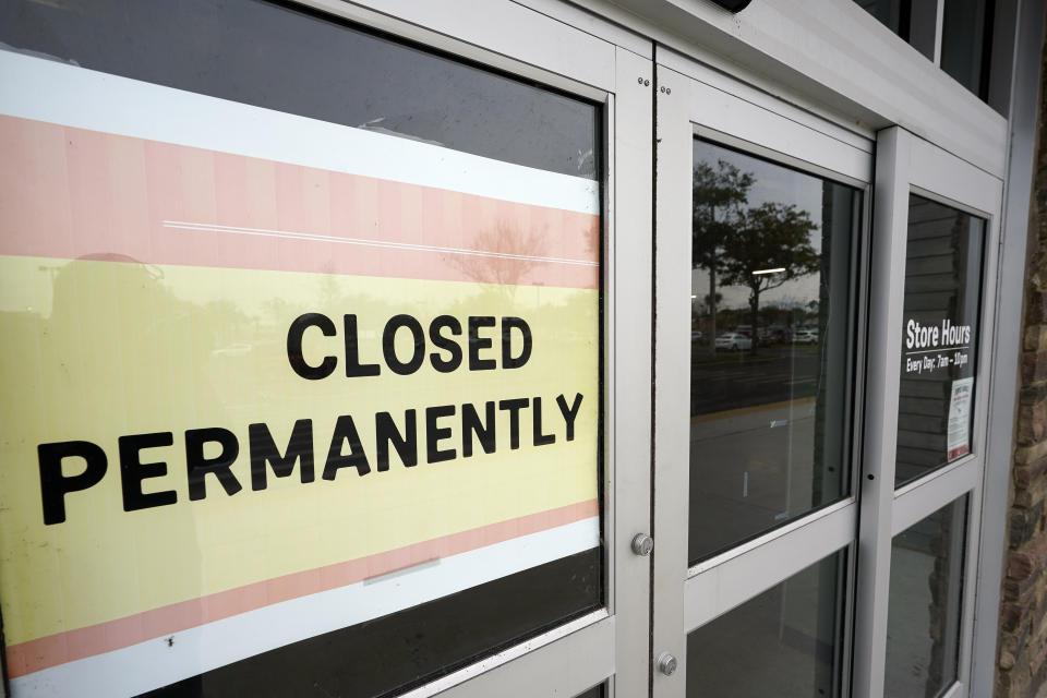 A business that has closed permanently displays a sign near the entrance, Tuesday, Jan. 12, 2021, in Orlando, Fla. The “For Rent” signs on storefronts and offices around the world provide a stark illustration of COVID's toll on small businesses. With government restrictions and fear keeping consumers out of restaurants, stores and other establishments, businesses that operate on narrow revenue streams have struggled the past year. Or, they’ve disappeared, leaving millions of workers unemployed. (AP Photo/John Raoux)