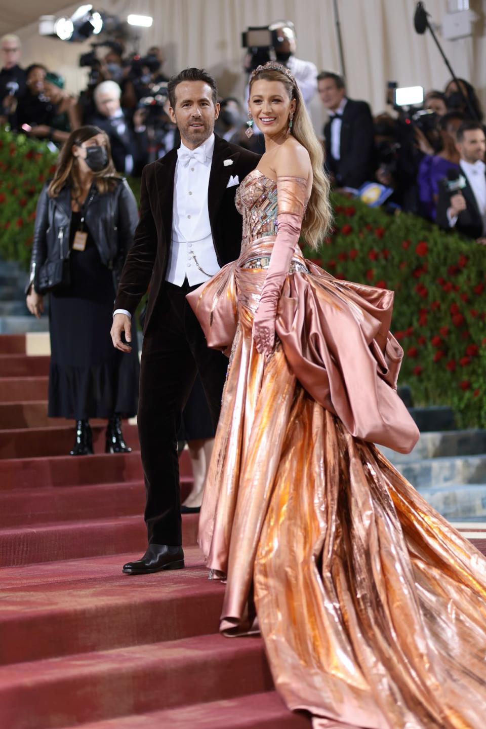 <div class="inline-image__caption"><p>Blake Lively (with husband Ryan Reynolds) always looks best when she leans into the maximalist appeal of her crowd-pleasing beauty and golden blond hair, and this look is an early highlight. Halfway up the steps, assistants unfurled Lively’s blush rose Atelier Versace bustle to reveal a Tiffany blue train. Her opera gloves changed hues too. <em>Bravissimo</em>!</p></div> <div class="inline-image__credit">Dimitrios Kambouris/Getty</div>