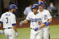Los Angeles Dodgers shortstop Corey Seager (5) celebrates after a three-run home run during the seventh inning in Game 2 of a baseball National League Championship Series against the Atlanta Braves Tuesday, Oct. 13, 2020, in Arlington, Texas. (AP Photo/Eric Gay)