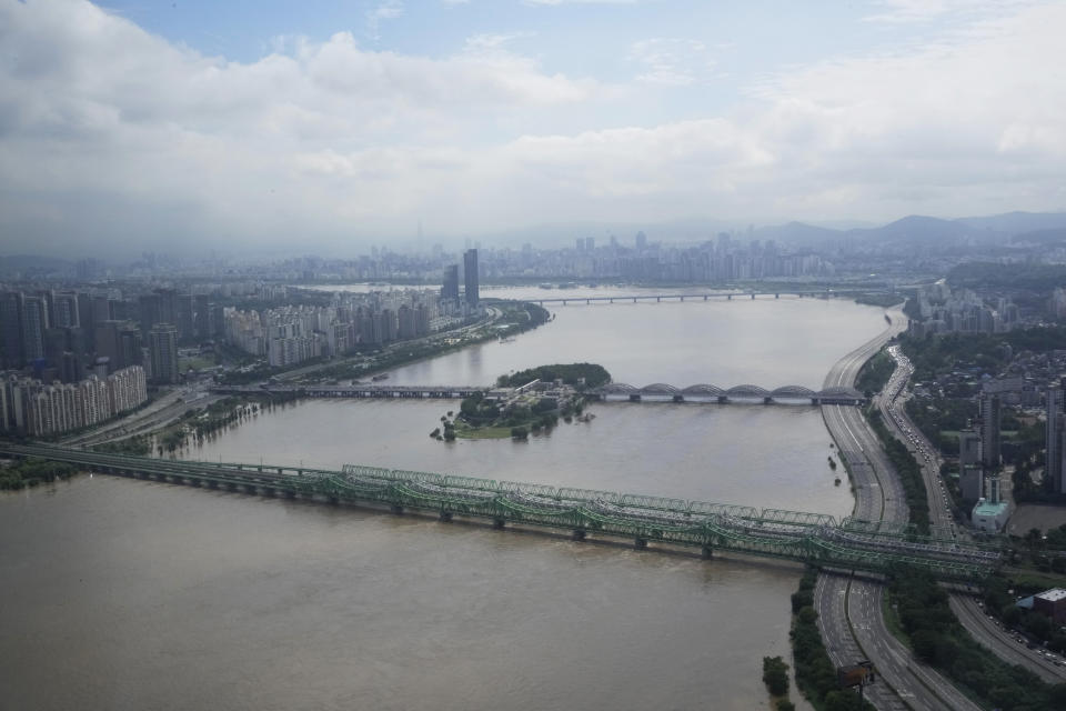 A part of a main road along the Han River is flooded due to heavy rain in Seoul, South Korea, Wednesday, Aug. 10, 2022. Cleanup and recovery efforts gained pace in South Korea's greater capital region Wednesday as skies cleared after two days of record-breaking rainfall that unleashed flash floods, damaged thousands of buildings and roads and killed multiple people. (AP Photo/Ahn Young-joon)