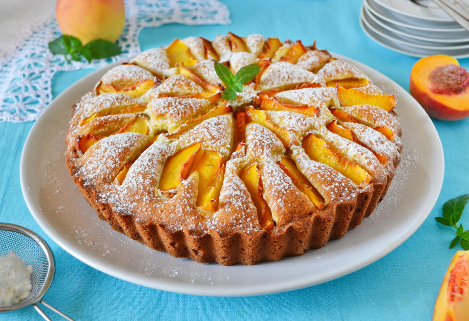 baked peach dessert on blue tablecloth