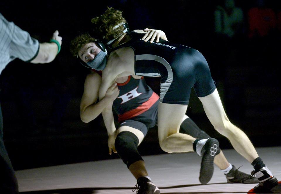 Holliston High School sophomore captain Zak Robinson (138 pounds) wrestles Bellingham's Logan Hampson on Jan. 26, 2022.