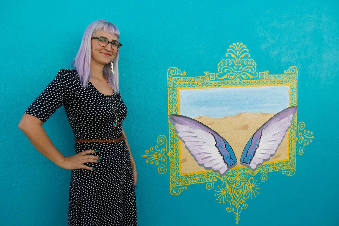 Artist Krista Jeffries stands in front of the painting she did for the “selfie wall” on the back of the First Class Seconds building located at 141 N. 6th St. in Grover Beach, in January 2020.