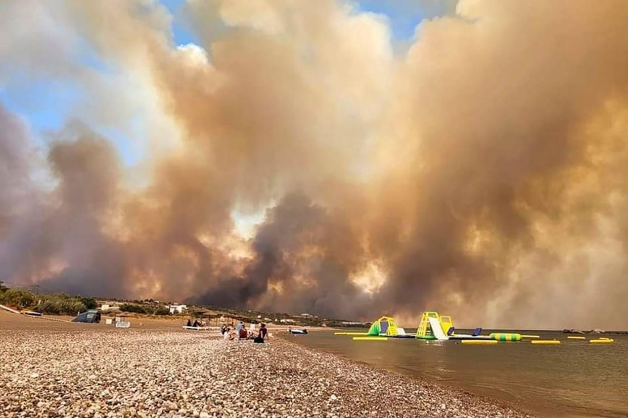 Clouds of smoke from a forest fire rise to the sky on the island of Rhodes (AP)