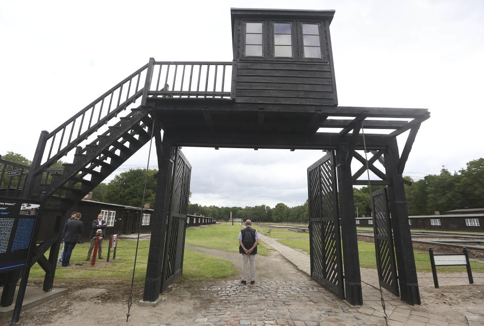 FILE - In this July 18, 2017 file photo, the wooden main gate leads into the former Nazi German Stutthof concentration camp in Sztutowo, Poland. 93-year-old former SS private Bruno Dey is going on trial at the criminal court in Hamburg on 5,230 counts of being an accessory to murder, accused of helping the Nazis' Stutthof concentration camp function. (AP Photo/Czarek Sokolowski, file)
