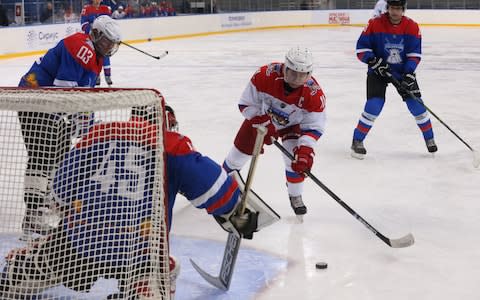 Mr Putin takes a shot on net during a hockey match on Friday - Credit: Mikhail Svetlov/Getty