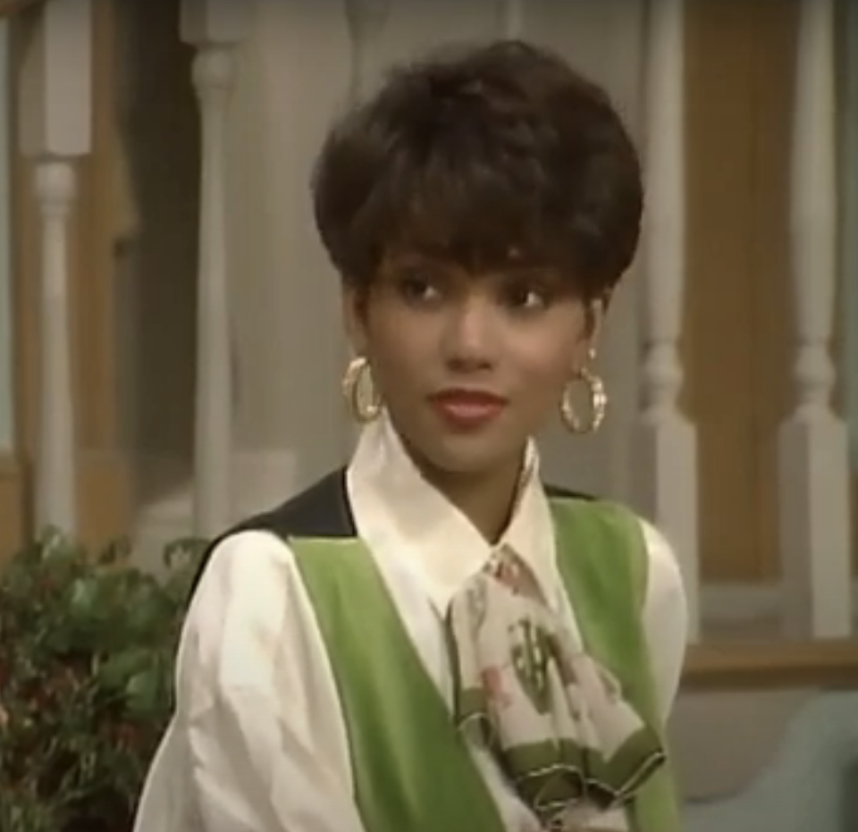 closeup of a younger halle with short hair and gold hoop earrings