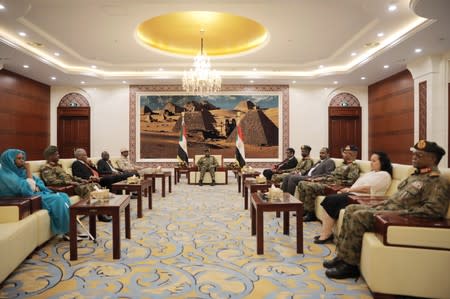 Leader of Sudan's transitional council, Lieutenant General Abdel Fattah Al-Abdelrahman Burhan meets military and civilian members of Sudan's new ruling body, the Sovereign Council, after their swearing-in ceremony at the presidential palace in Khartoum