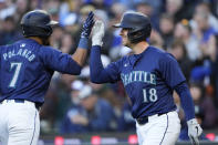 Seattle Mariners' Jorge Polanco is greeted by Mitch Garver (18) after Polanco hit a two-run home run against the Atlanta Braves during the third inning of a baseball game Tuesday, April 30, 2024, in Seattle. (AP Photo/Lindsey Wasson)