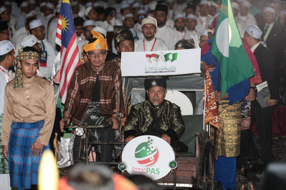 PAS Youth chief Muhammad Khalil Abdul Hadi and PAS deputy president Datuk Tuan Ibrahim Tuan Man enter the main hall at the start of Pemuda proceedings during Muktamar 2019 in Gambang, Pahang June 19, 2019. — Picture by Zamzahuri Abas