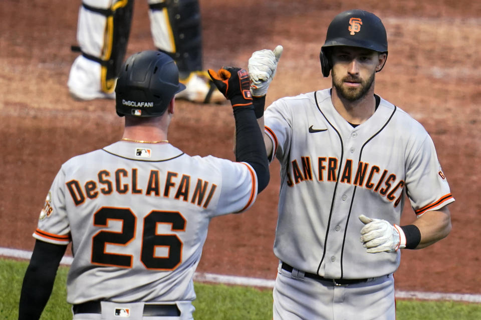 San Francisco Giants' Steven Duggar, right, is greeted by Anthony DeSclafani as he returns to the dugout after hitting a solo home run off Pittsburgh Pirates starting pitcher Wil Crowe during the fifth inning of a baseball game in Pittsburgh, Thursday, May 13, 2021.(AP Photo/Gene J. Puskar)