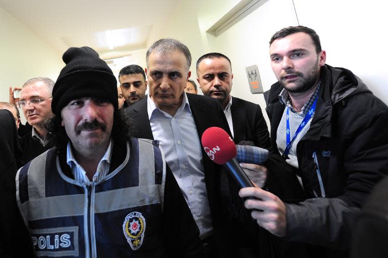 Ekrem Dumanli (C), editor-in-chief of Zaman newspaper, Turkey's top-selling newspaper, is detained by counter-terror police at the newspaper's headquarters in Istanbul on December 14, 2014