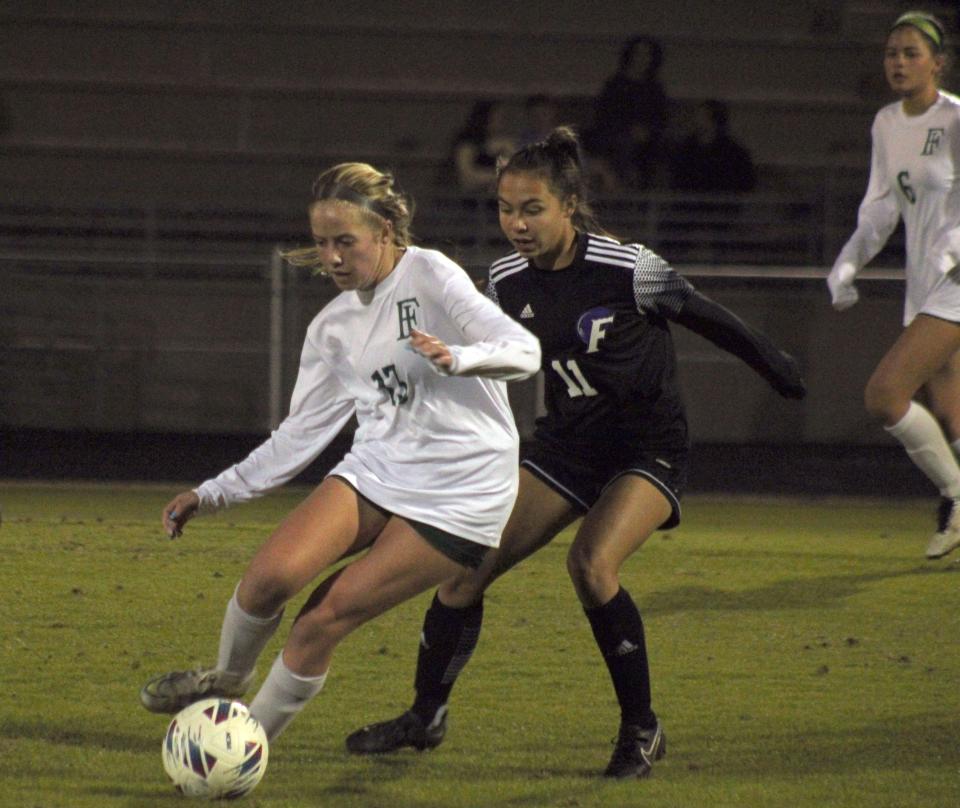 Fleming Island midfielder Kaitlyn Scherer (13) dribbles as Fletcher midfielder Allison Aquino (11) defends during an FHSAA District 3-6A high school girls soccer semifinal on January 27, 2023. [Clayton Freeman/Florida Times-Union]