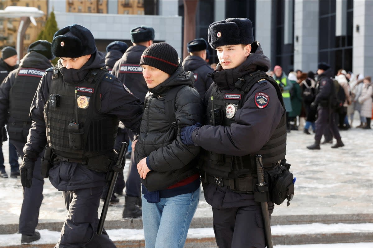Police officers detain an individual as protests were held in Moscow on Saturday (REUTERS/Stringer)