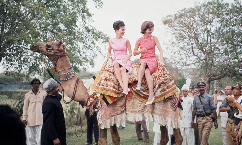 Jacqueline Kennedy, right, perches on camel with her sister, Lee Radziwill, in Karachi in March 1962.