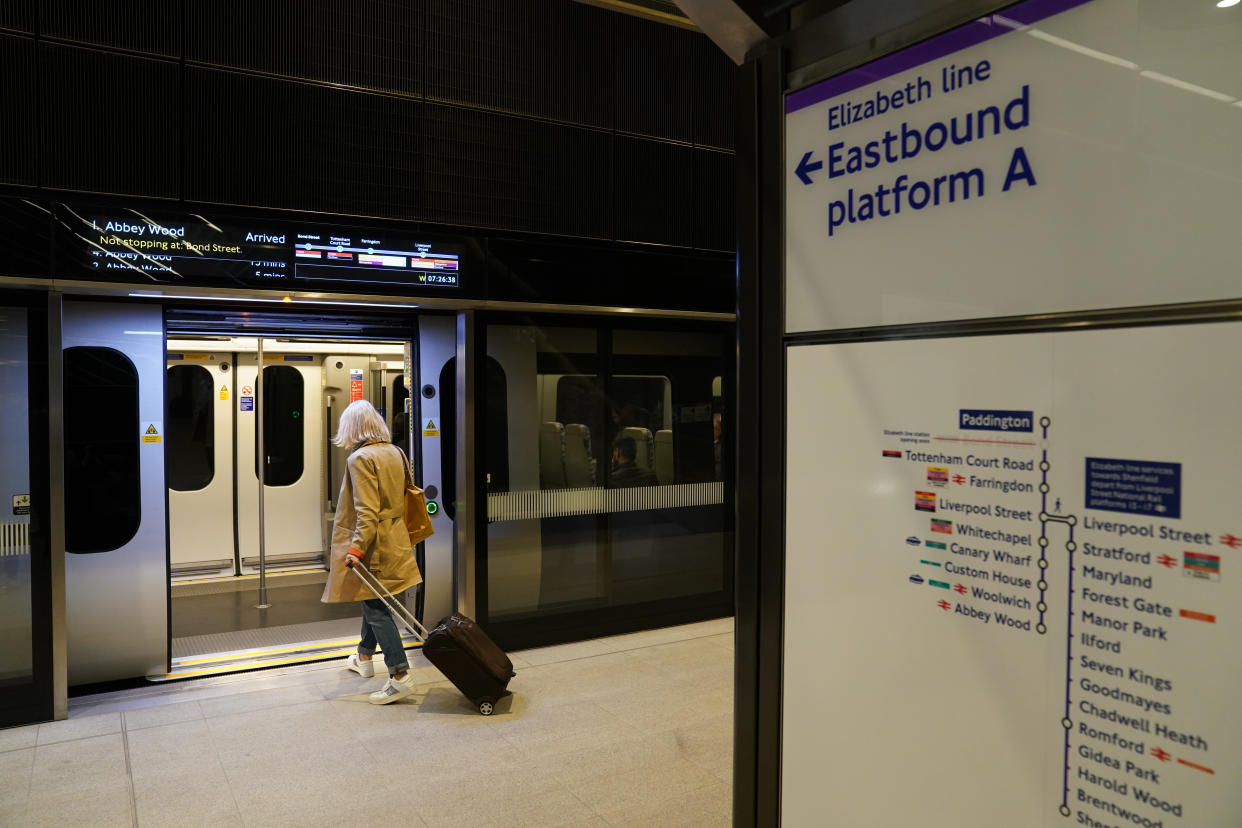 A passenger boards an Elizabeth Line carriage at Paddington Station, London, as the new line opens to passengers for the first time. The delayed and overbudget line will boost capacity and cut journey times for east-west travel across the capital. Picture date: Tuesday May 24, 2022.