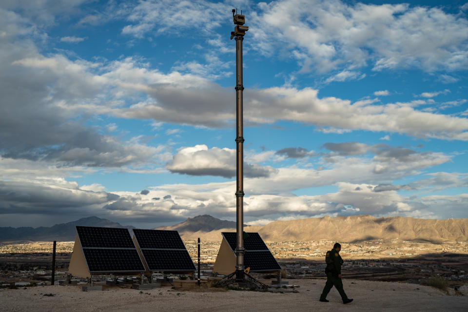 SUNLAND PARK, NEW MEXICO - JANUARY 18: A Border Patrol agent walks by an Autonomous Surveillance Towers, the new CBP camera tower made by Anduril next to a border wall near Sunland Park, New Mexico, Tuesday, January 18, 2022. (Photo by Salwan Georges/The Washington Post via Getty Images)