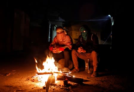 The Wider Image: Barricades and books in restive Kashmir neighbourhood