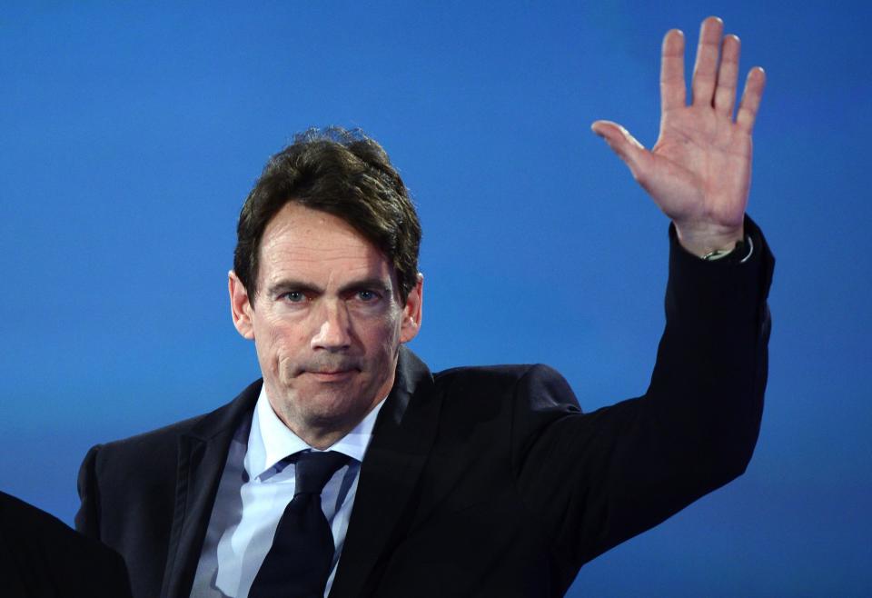 Parti Quebecois candidate Pierre Karl Peladeau waves on the stage before PQ leader Pauline Marois' speech on Monday April 7, 2014 in Montreal. Marois lost her seat in Charlevoix-Cote-de-Beaupre to Liberal candidate Caroline Simard. (AP Photo/The Canadian Press, Paul Chiasson)