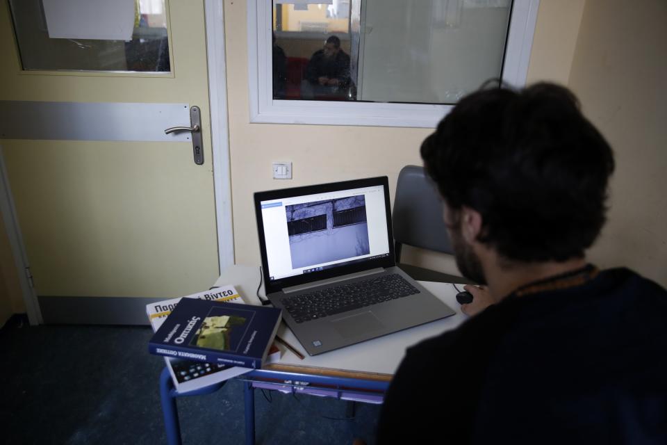 An inmate checks a photo before taking online exams for his university exams photography and audiovisual arts course, at Avlona's prison school, north of Athens, Wednesday, Feb. 10, 2021. With Greece's schools shut due to the pandemic, all lessons have gone online. But the online world isn't within reach of everyone _ and particularly not within reach of the students of Avlona Special Youth Detention Center, where internet devices are banned by law from the cells. (AP Photo/Thanassis Stavrakis)