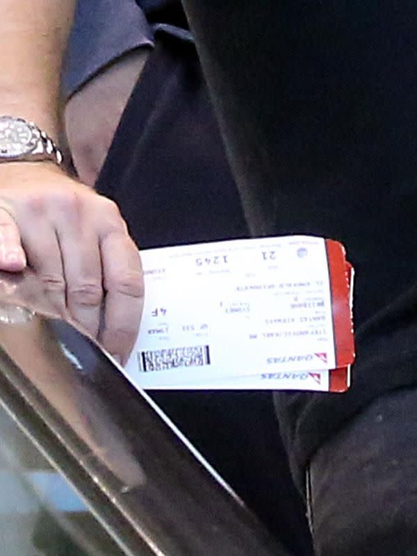 Karl holding two boarding passes whilst exiting Sydney airport. Source: Diimex