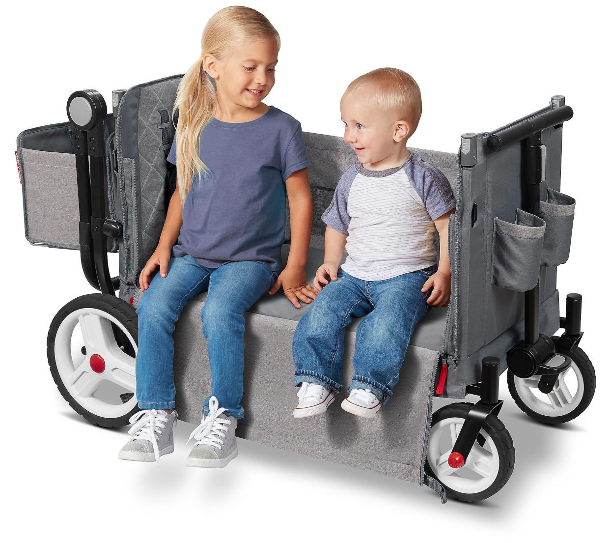 Toddler girl and little boy sitting in open side of Radio Flyer wagon