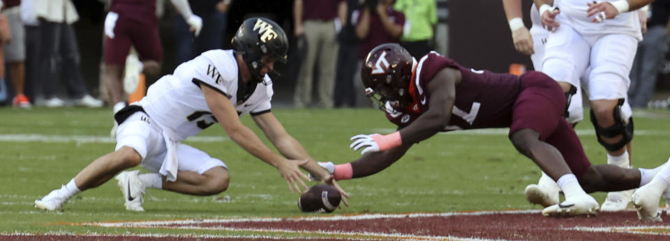 Virginia Tech defender Antwaun Powell-Ryland ,right, recovers a fumble by Wake Forest quarterback Michael Kern (15) in the first half of an NCAA college football game in Blacksburg, Va., Saturday, Oct. 14, 2023. (Matt Gentry/The Roanoke Times via AP)