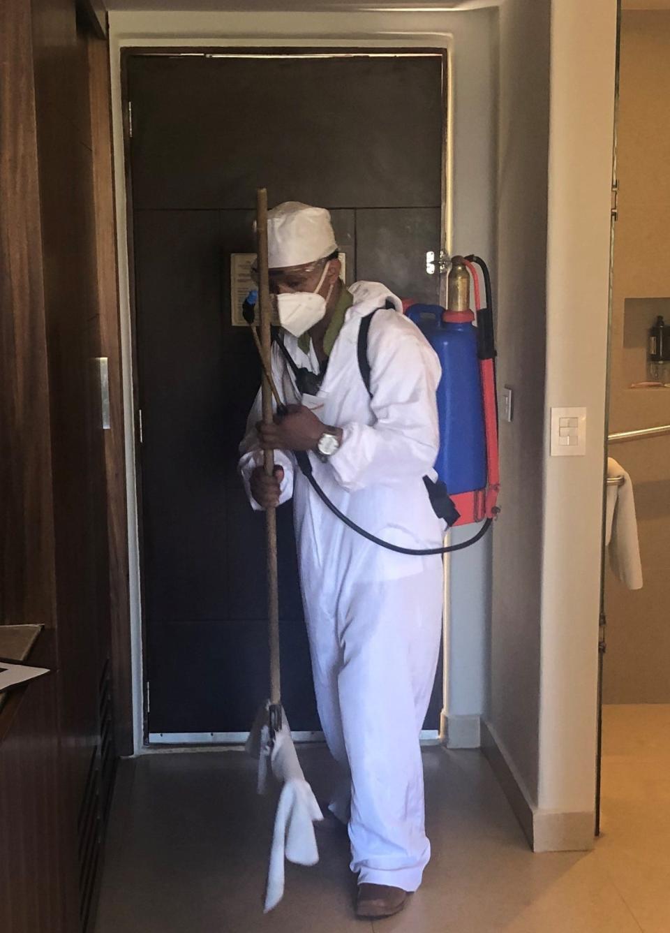 An employee at the Fiesta Americana Condesa Cancun, an all-inclusive resort in Mexico, sanitizes a guest room.