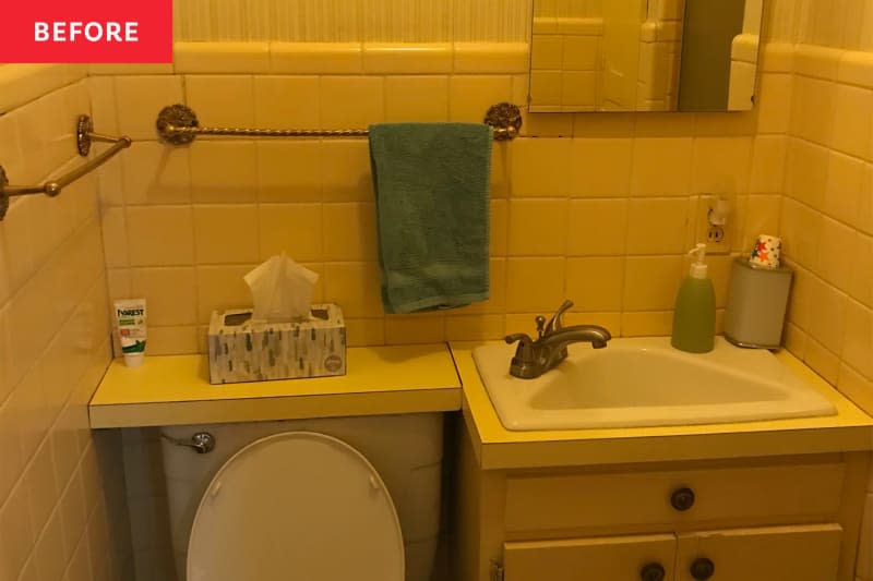 Dated tiled bathroom with vanity in right corner and toilet on left