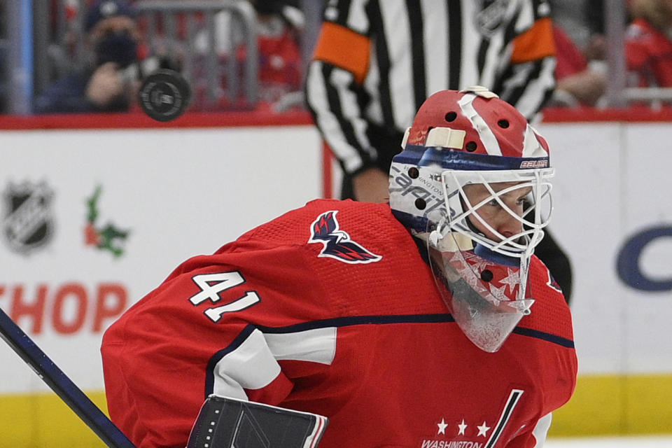 The puck flies past Washington Capitals goaltender Vitek Vanecek (41) during the second period of the team's NHL hockey game against the Chicago Blackhawks, Thursday, Dec. 2, 2021, in Washington. (AP Photo/Nick Wass)