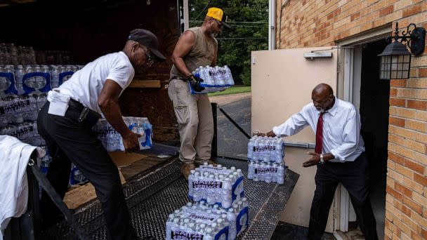 PHOTO: Members of Progressive Morningstar Baptist Church move cases of water following a Sunday morning service in Jackson, Miss., on Sept. 4, 2022. (Seth Herald/AFP via Getty Images)