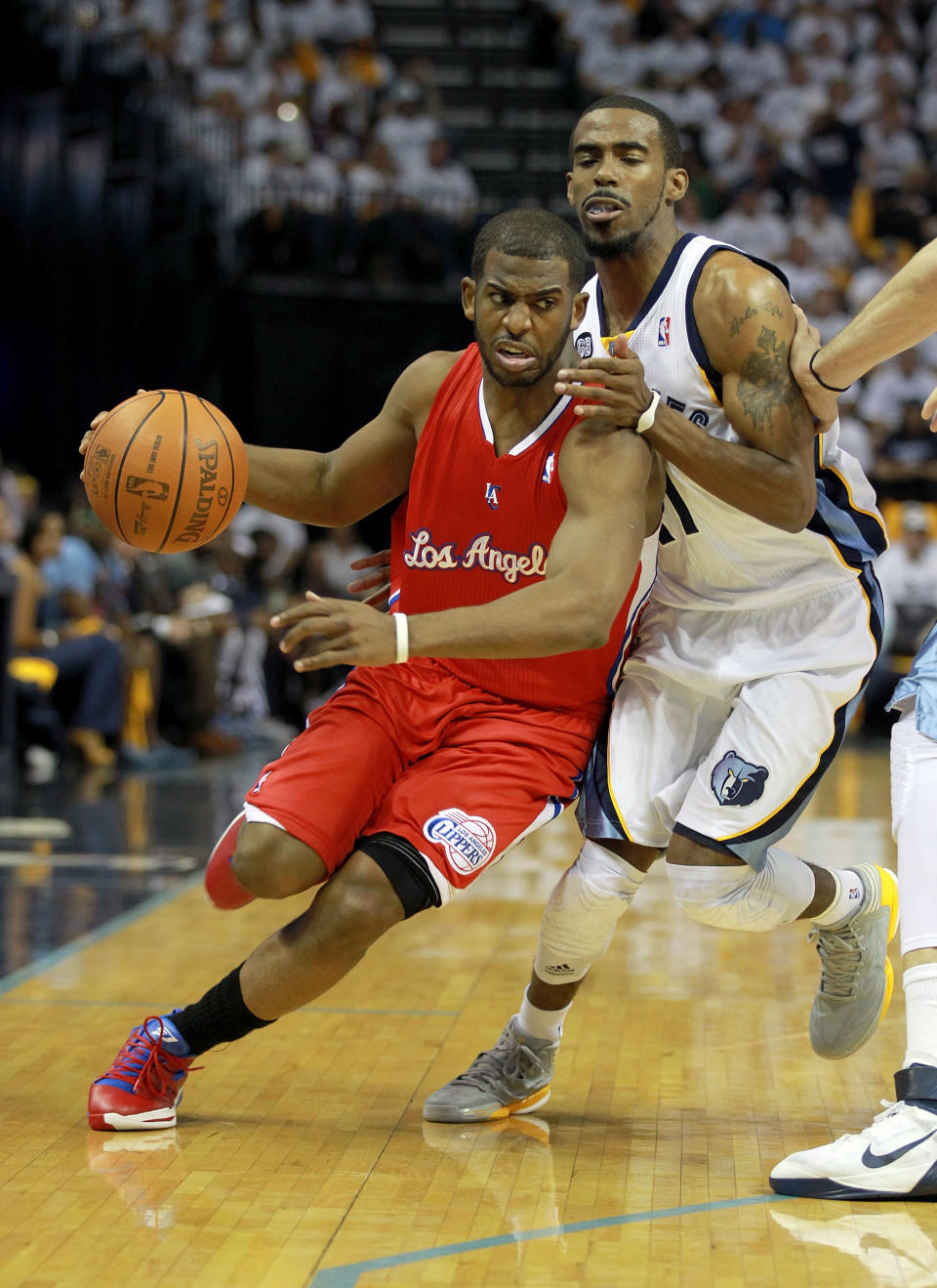 MEMPHIS, TN - APRIL 29: Chris Paul #3 of the Los Angeles Clippers dribbles the ball while defended by Mike Conley #11 of the Memphis Grizzlies the in Game One of the Western Conference Quarterfinals in the 2012 NBA Playoffs at FedExForum on April 29, 2012 in Memphis, Tennessee. NOTE TO USER: User expressly acknowledges and agrees that, by downloading and or using this photograph, User is consenting to the terms and conditions of the Getty Images License Agreement. (Photo by Andy Lyons/Getty Images)
