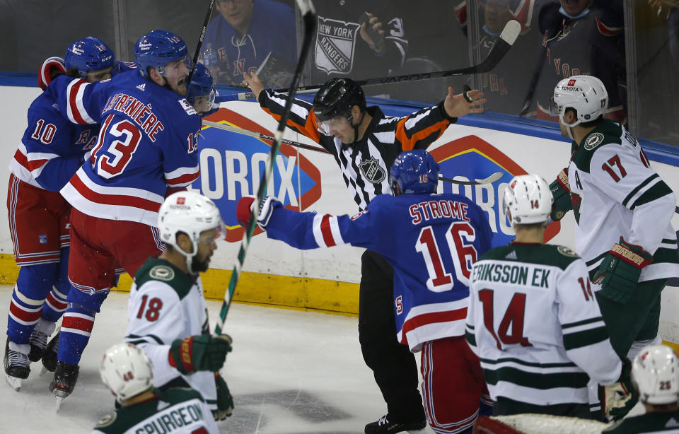 Referee Jon McIsaac (2) signals no goal after the New York Rangers thought they had tied the score with two seconds left during the third period of an NHL hockey game against the Minnesota Wild, Friday, Jan. 28, 2022, in New York. (AP Photo/John Munson)