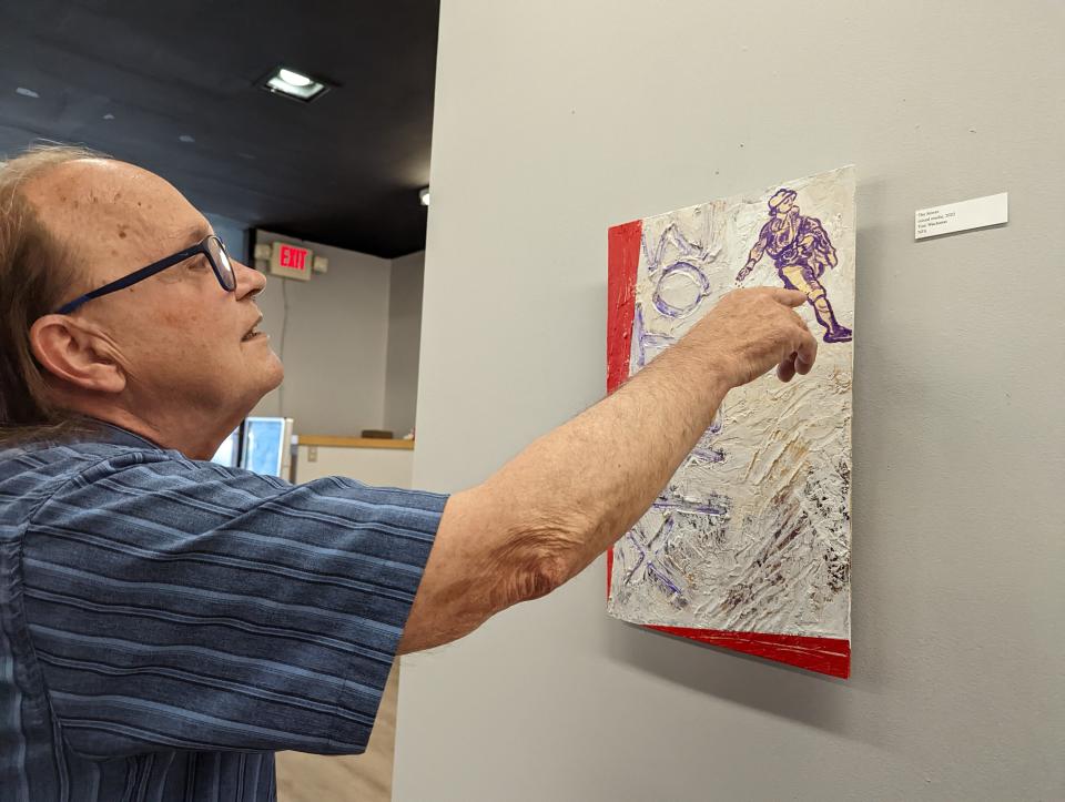 Artist Tom Wachunas discusses  his artwork, "The Sower," which is part of his current exhibit at the Patina Arts Centre in downtown Canton.