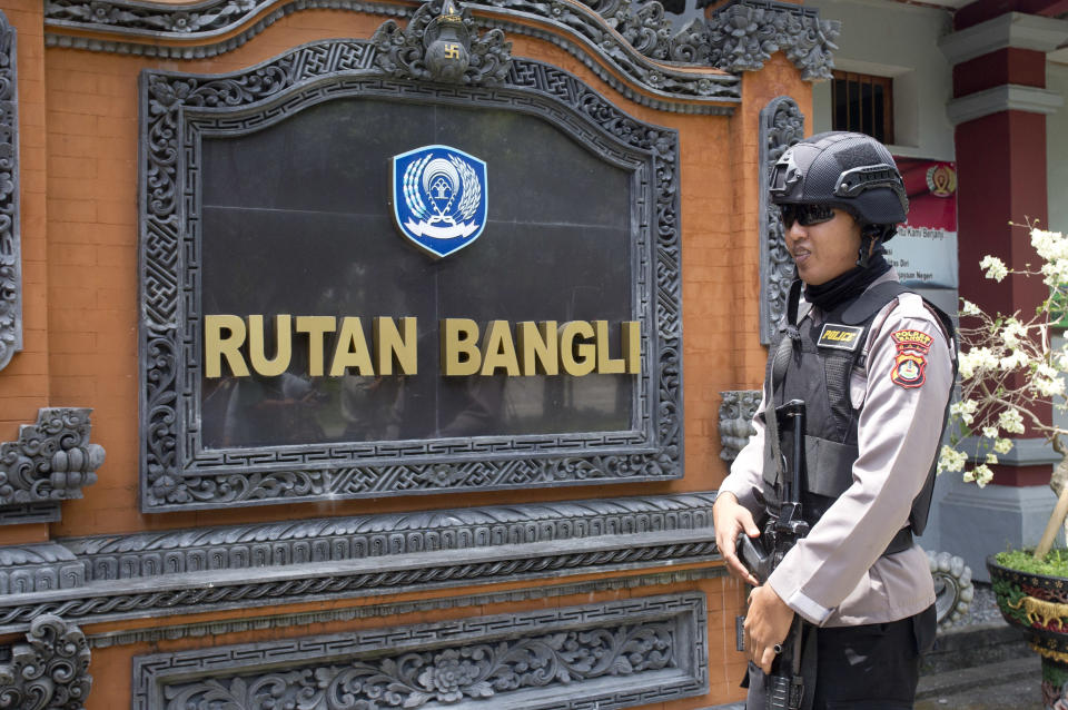 A police officer stands guard at Bangli prison in Bali, Indonesia, Wednesday, Nov. 21, 2018. Australian woman Renae Lawrence freed Wednesday after serving nearly 14 years in prison for smuggling heroin to the tourist island of Bali will be deported and banned from the country for life. (AP Photo/Firdia Lisnawati)