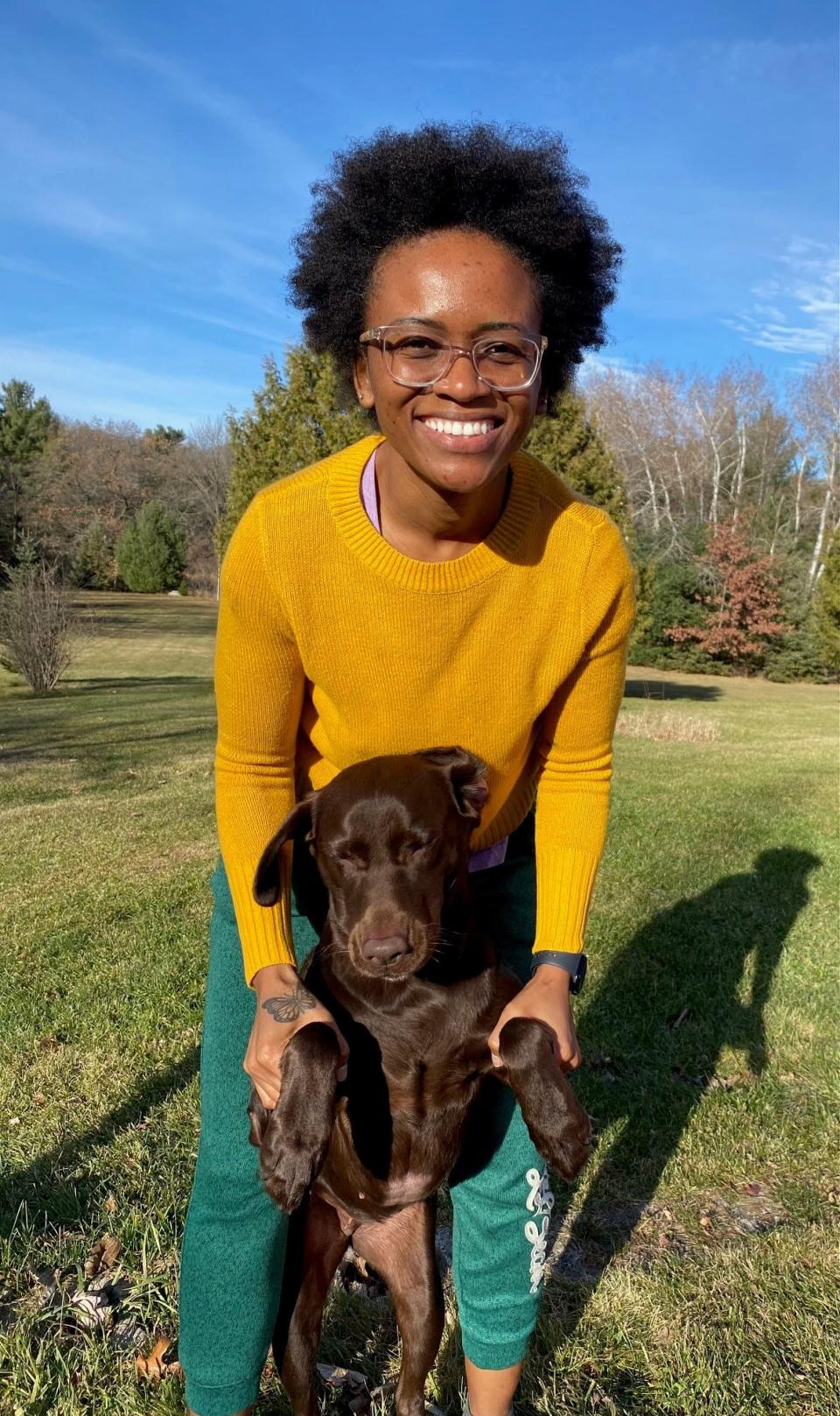 Dineo Dowd plays around with her dog, Zulu, on family property located just outside of Poy Sippi in Waushara County.