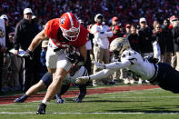 Georgia tight end Brock Bowers (19) gets past Charleston Southern defensive back Kamron Smith (47) to score a touchdown after a catch in the first half of an NCAA college football game Saturday, Nov. 20, 2021, in Athens, Ga. (AP Photo/John Bazemore)