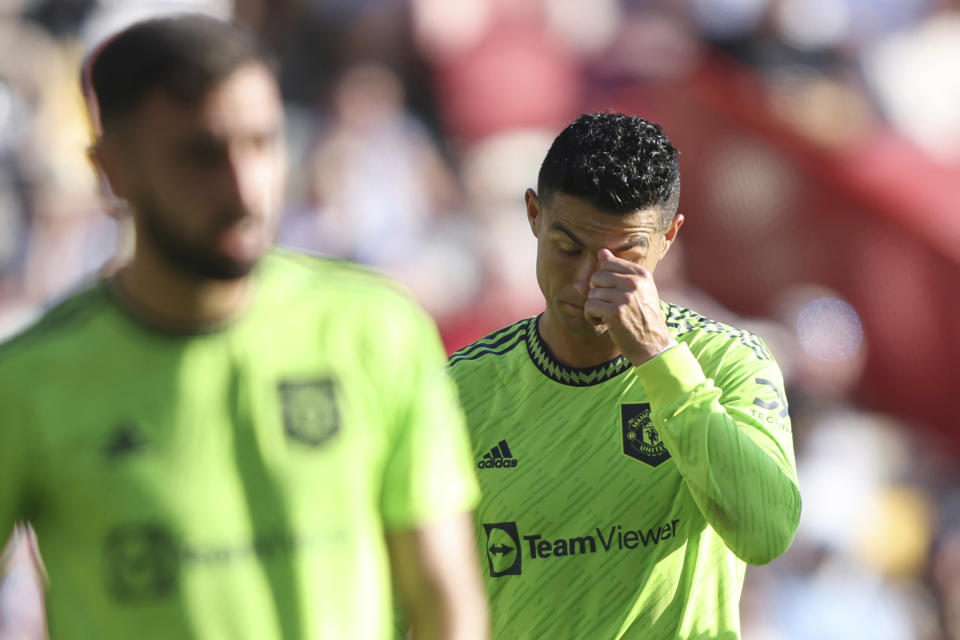 Manchester United's Cristiano Ronaldo right reacts as his team lose another goal to Brentford during the English Premier League soccer match between Brentford and Manchester United at the Gtech Community Stadium in London, Saturday, Aug. 13, 2022. (AP Photo/Ian Walton)