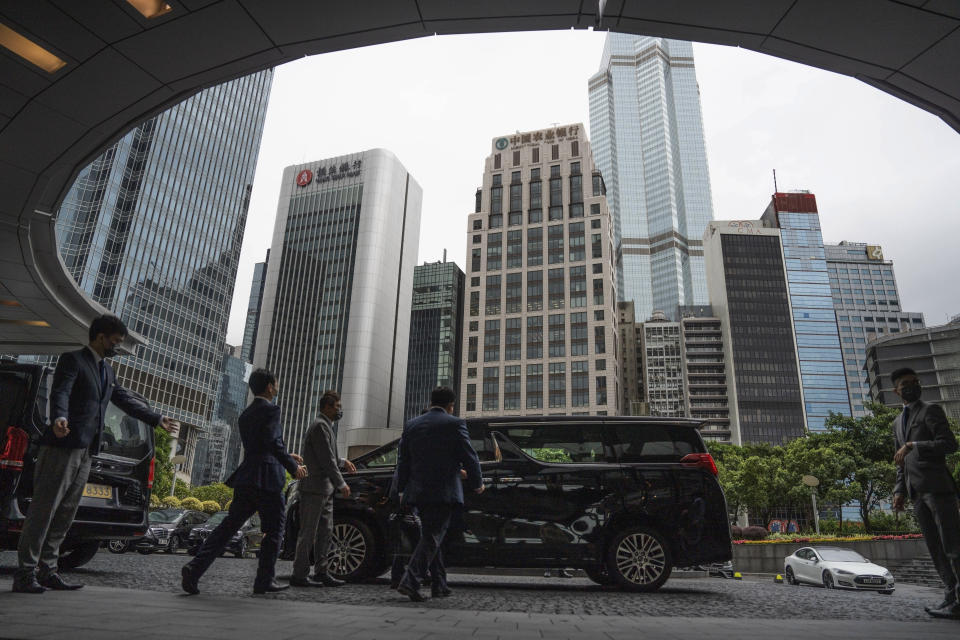 Guests leave from the Global Financial Leaders' Investment Summit in Hong Kong, Wednesday, Nov. 2, 2022. Severe tropical storm Nalgae edged closer to Hong Kong on Wednesday and forced businesses to close, but the finance summit that's meant to restore the city's image as an international financial hub pressed ahead. (AP Photo/Bertha Wang)