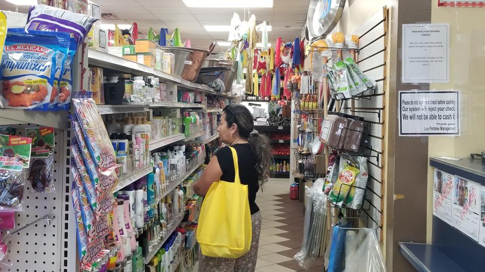 A customer spends time shopping at the  Los Portales Supermarket.