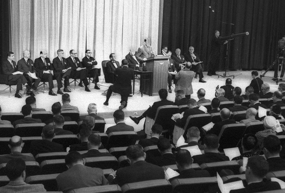 FILE - In this Jan. 11, 1964, file photo U.S. Surgeon General Luther Terry answers questions on an exhaustive report on the dangers of smoking during a news conference in Washington. Members of his advisory committee, are, from left: Dr. Peter V.V. Hamill, Dr. Stanhope Bayne-Jones, Dr. Walter J. Burdette, Prof. William G. Cochan, Dr. Walter J. Burdette, Prof.William G. Cochran, Dr. John B. Hickman, Dr. Emmanuel Farber, Dr. James Hund, committe vice chairman, Dr. Louis F. Fieser, Dr. Terry, Dr. Charles LeMaistre, rear, Dr. Eugene H. Guthrie,staff director, Dr. Maurice H. Seevers, and Dr. Leonard M. Scdhuman. (AP Photo)