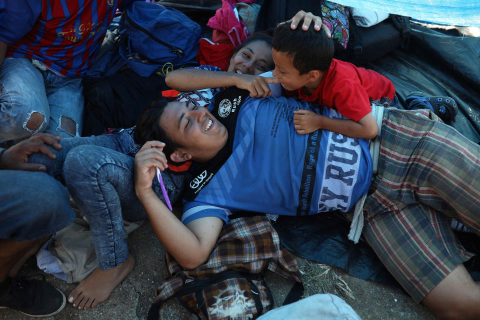 <p>A Central American migrant family from Honduras participating in the annual Migrant Stations of the Cross caravan or “Via crucis,” organized by the “Pueblo Sin Fronteras” activist group, joke around as they rest at a sports center during the caravan’s few-days stop in Matias Romero, Oaxaca state, Mexico, Monday, April 2, 2018. A Mexican government official said the caravans are tolerated because migrants have a right under Mexican law to request asylum in Mexico or to request a humanitarian visa allowing travel to the U.S. border to seek asylum in the United States. (Photo: Felix Marquez/AP) </p>