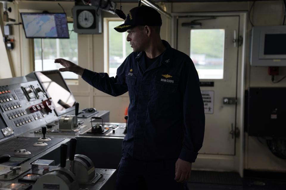 Captain Colin Little explains how he controls the NOAA Okeanos Explorer during a tour, Friday, June 23, 2023, in Kodiak, Alaska. The ship, a reconfigured former U.S. Navy vessel run by civilians and members of the NOAA Corps, is specially outfitted with technology and tools needed to access deep into the ocean, and to share that data with the public and on-shore researchers in real-time. (AP Photo/Joshua A. Bickel)