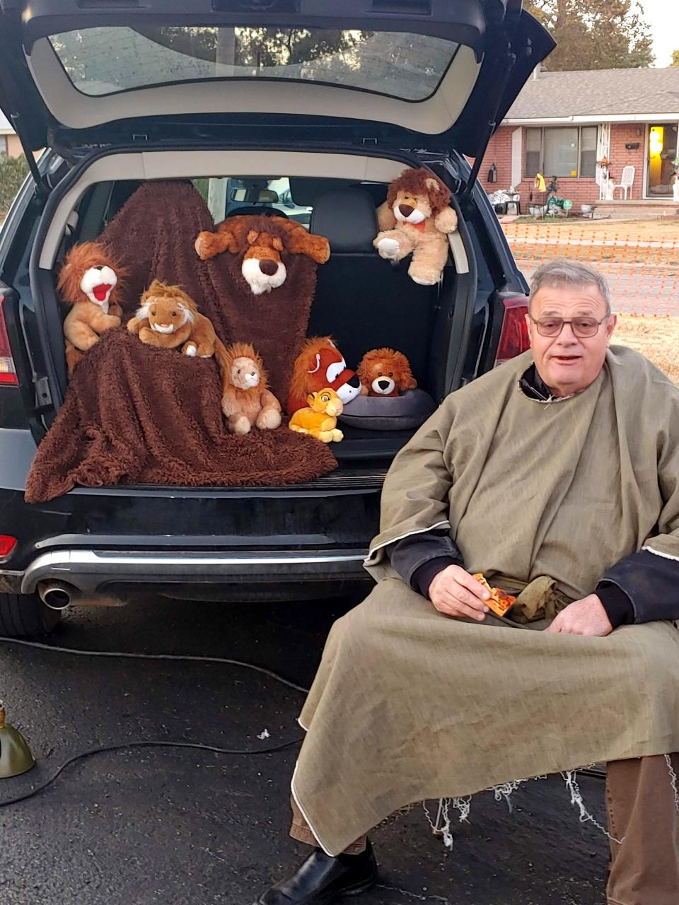 An OKC Bible Methodist Church member greets visitors to his Daniel and the Lion's Den station during a Gospel Trunk-or-Treat station at the South Oklahoma City church. [Provided]