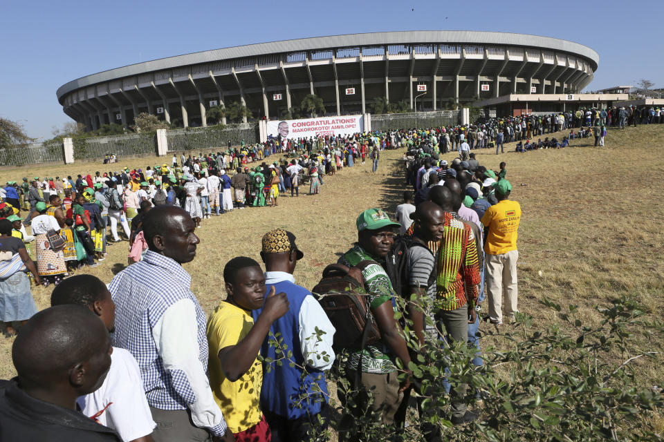 People queue to enter the stadium for the inauguration ceremony of Zimbabwean President Emmerson Mnangagwa, at the National Sports Stadium in Harare, Sunday, Aug. 26, 2018. This is the second swearing-in of Mnangagwa in just nine months as a country once jubilant over the fall of longtime leader Robert Mugabe is now more subdued after the reemergence of harassment of the opposition. (AP Photo/Tsvangirayi Mukwazhi)