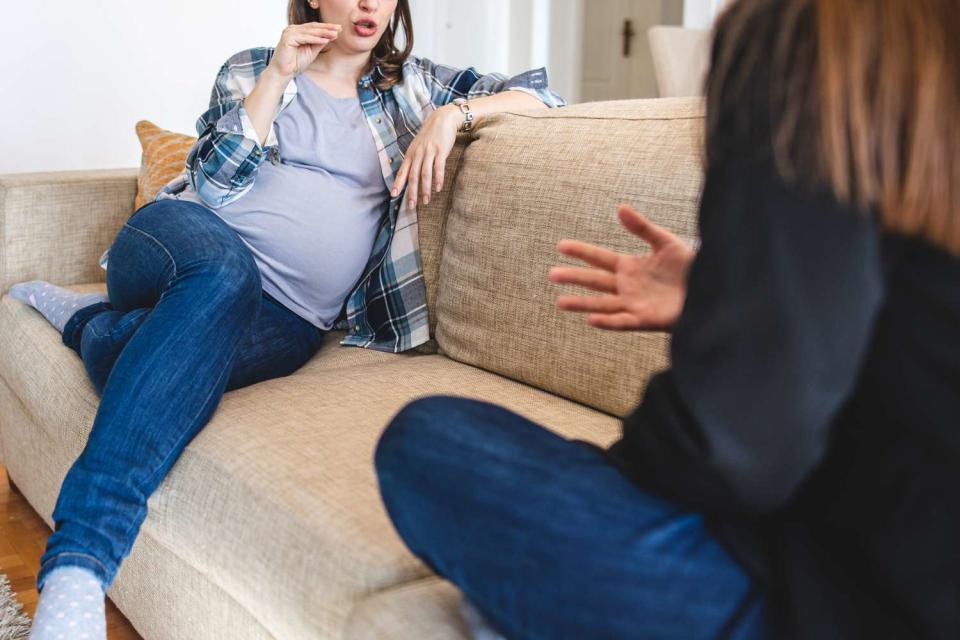 <p>Getty</p> Pregnant woman arguing with another woman