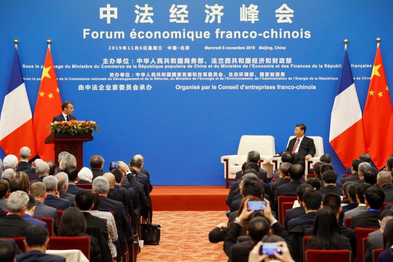 French President Emmanuel Macron and Chinese President Xi Jinping attend a China-France Economic Forum at the Great Hall of the People in Beijing