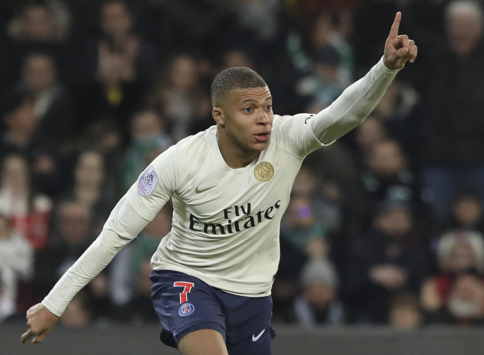 PSG forward Kylian Mbappe celebrates after scoring the opening goal during the French League One soccer match between Saint-Etienne and Paris Saint-Germain, at the Geoffroy Guichard stadium, in Saint-Etienne, central France, Sunday, Feb. 17, 2019. (AP Photo/Laurent Cipriani)